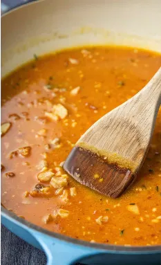 Rich pan sauce with garlic in a skillet.