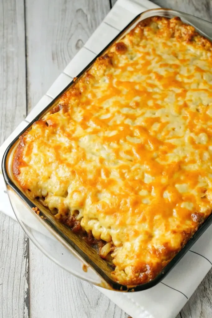 Baked Mac and Cheese Meatloaf Casserole with a golden, bubbly layer of melted cheese on top.